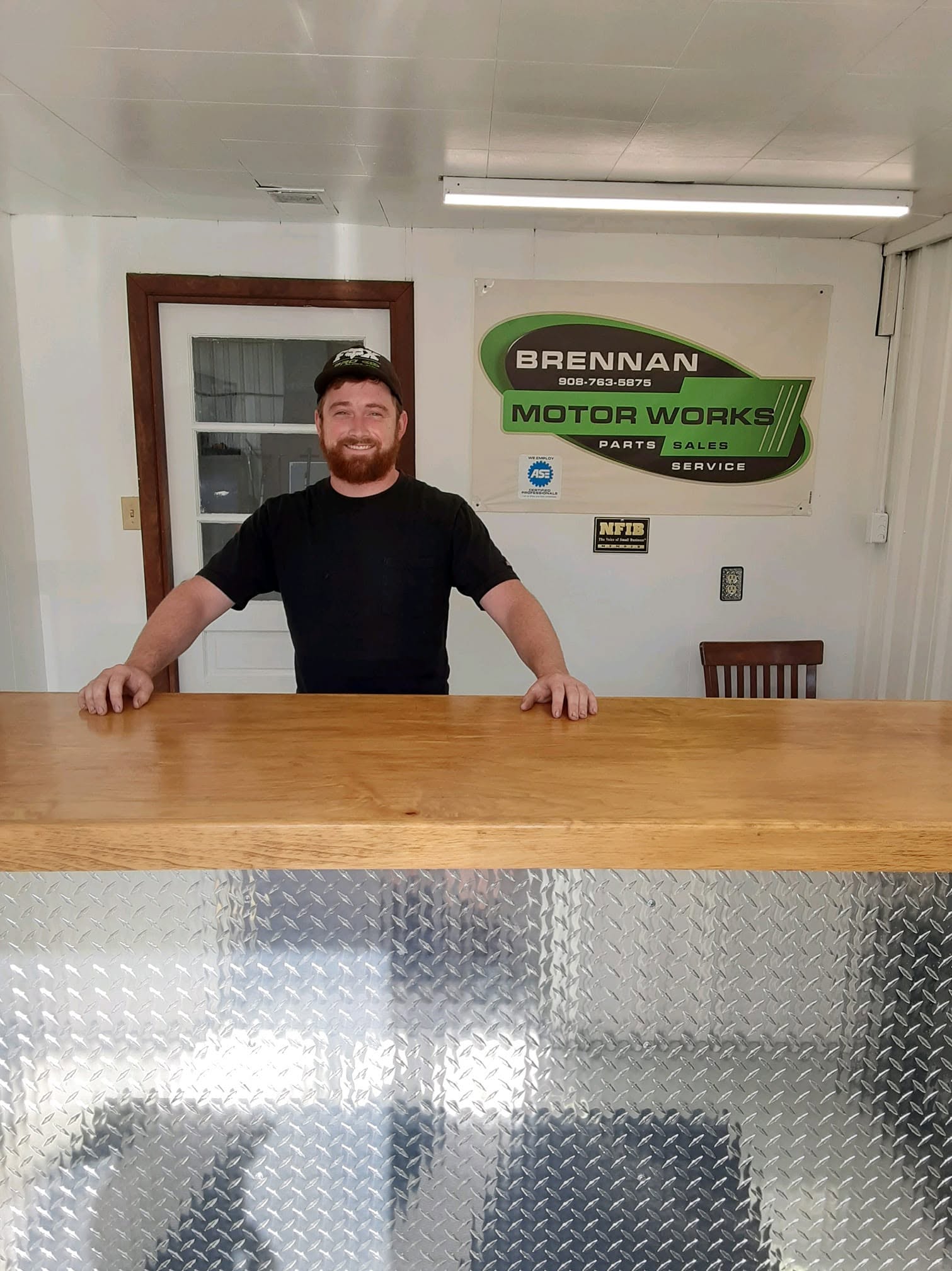 Jack Brennan at the Brennan Motorworks shop counter